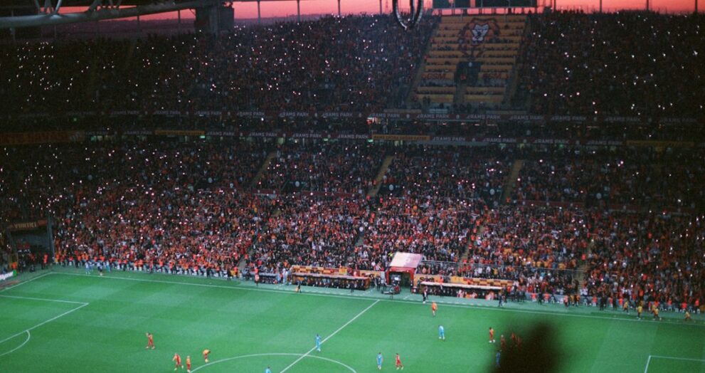 Crowd watching a Champions League style night match