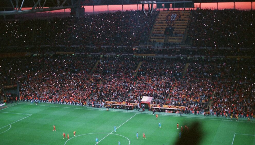 Crowd watching a Champions League style night match