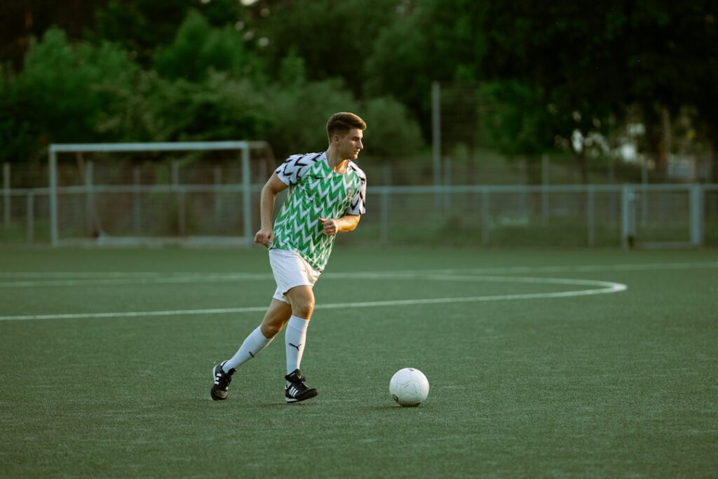 Player kicking the ball during a tactical match