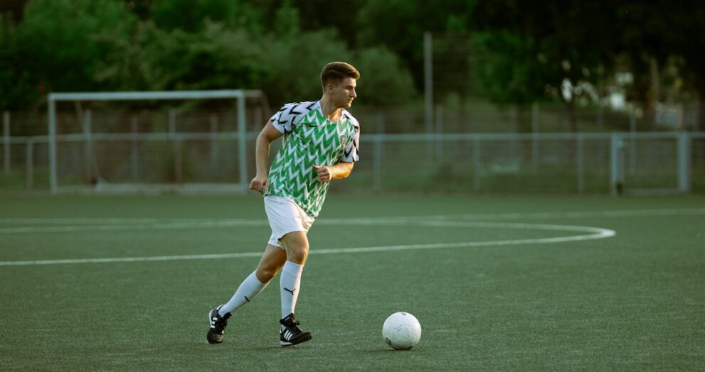 Player kicking the ball during a tactical match