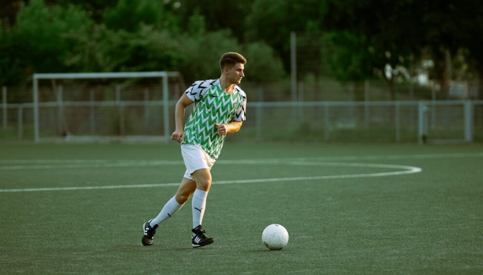 Player kicking the ball during a tactical match