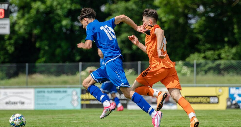Footballer running across the pitch in position