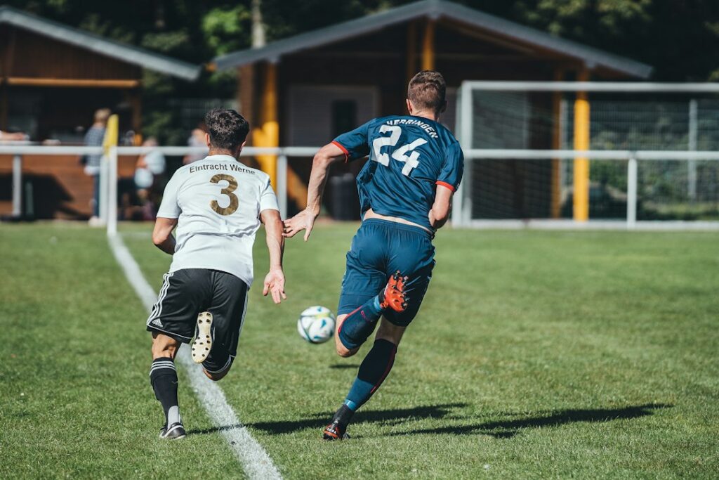 Two footballers competing for the ball