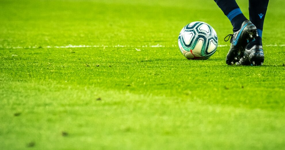 Footballer dribbling the ball during a match