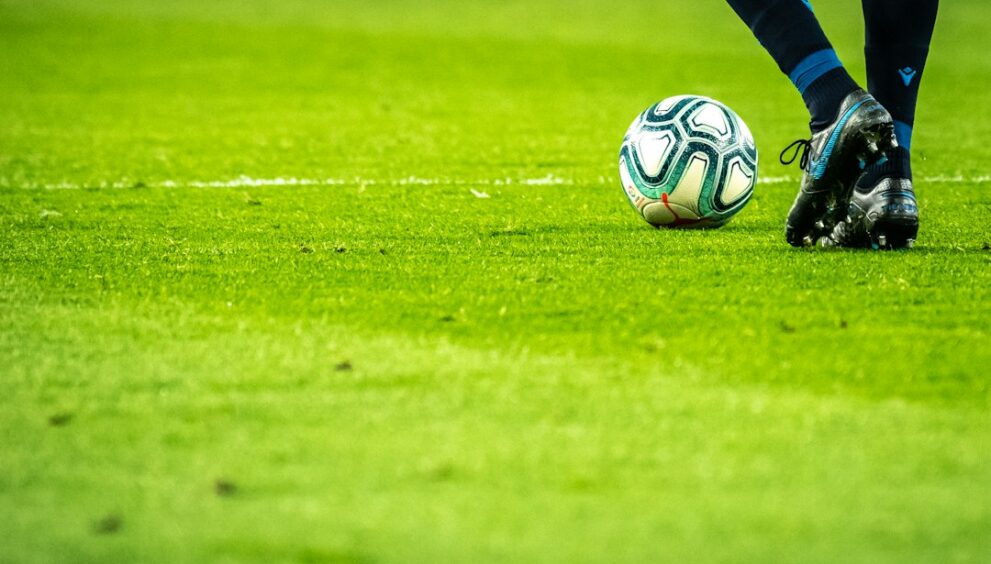 Footballer dribbling the ball during a match